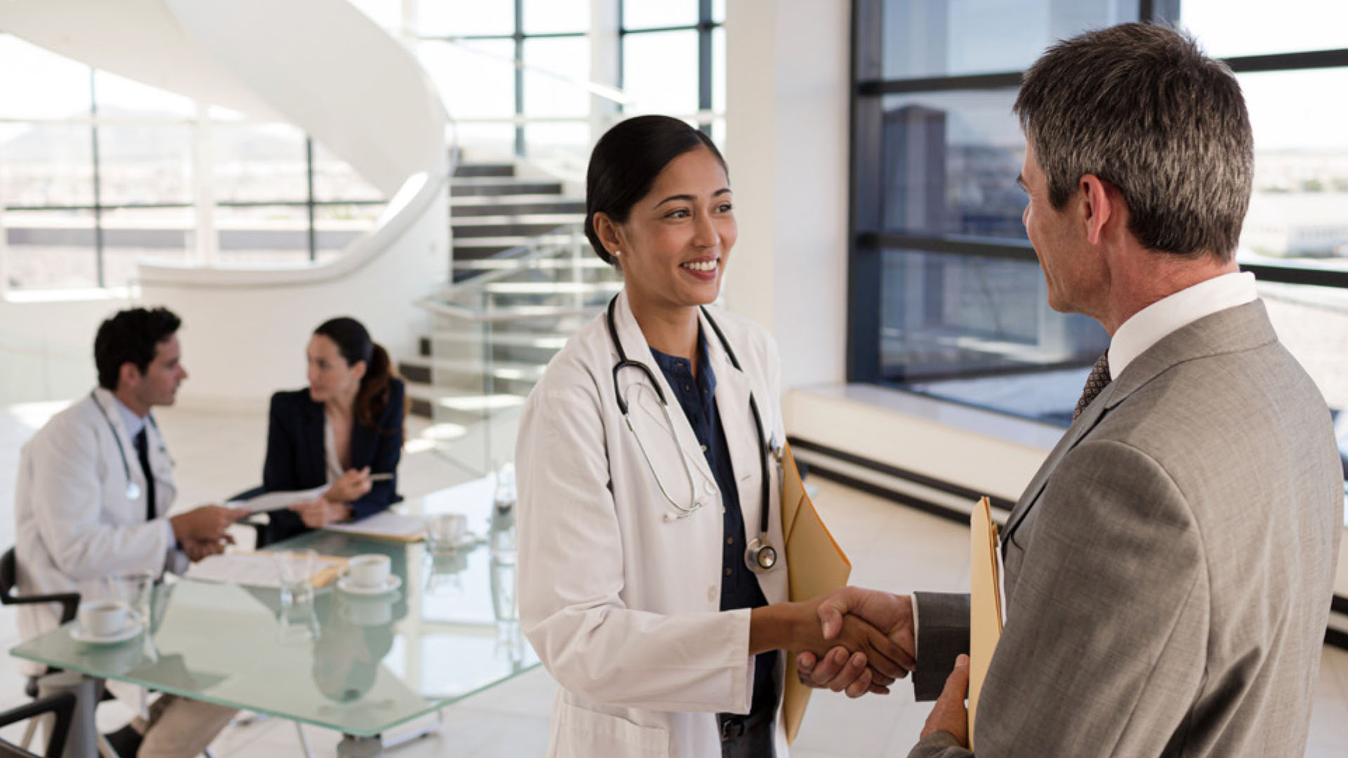 Healthcare professional and investor meeting in a medical office setting